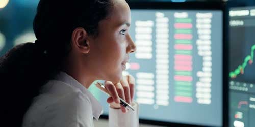 Person looking at a computer with financial information.